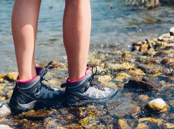 Scarpe immerse nelle acque di un torrente